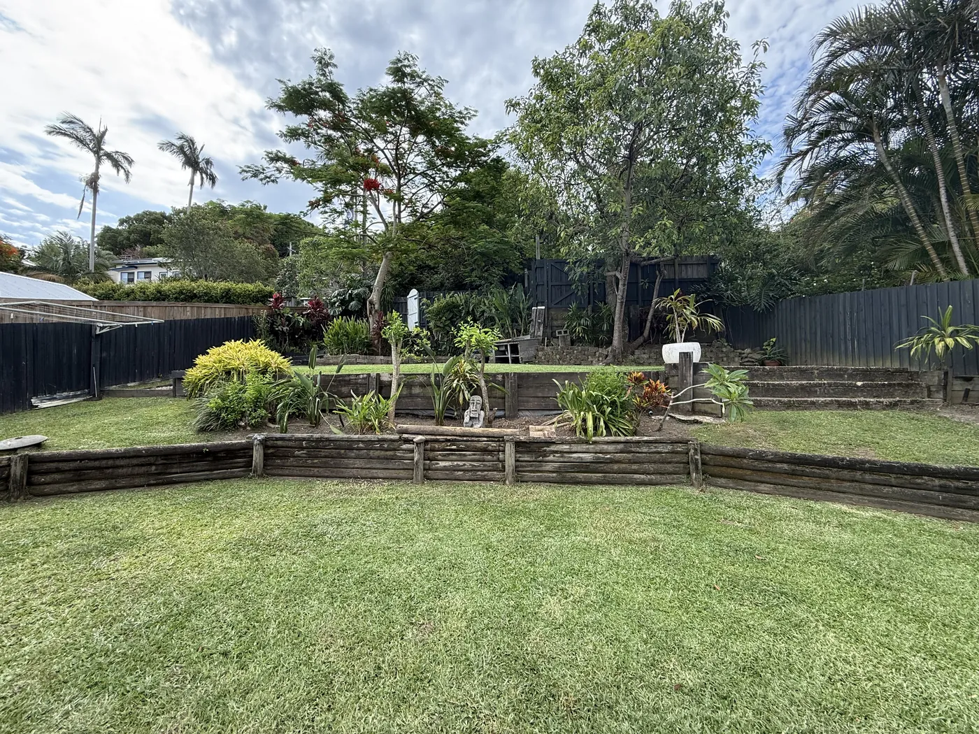 Timber retaining wall garden bed beside a fresh lawn