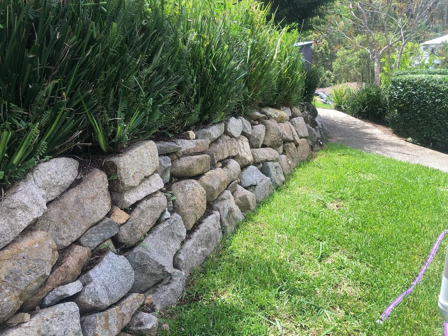 Stone wall beside a tidy lawn